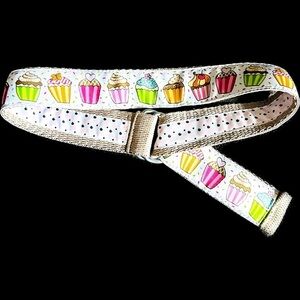 Belt, cupcakes and reverses to hearts on backside Celebrate in style.Adjustable